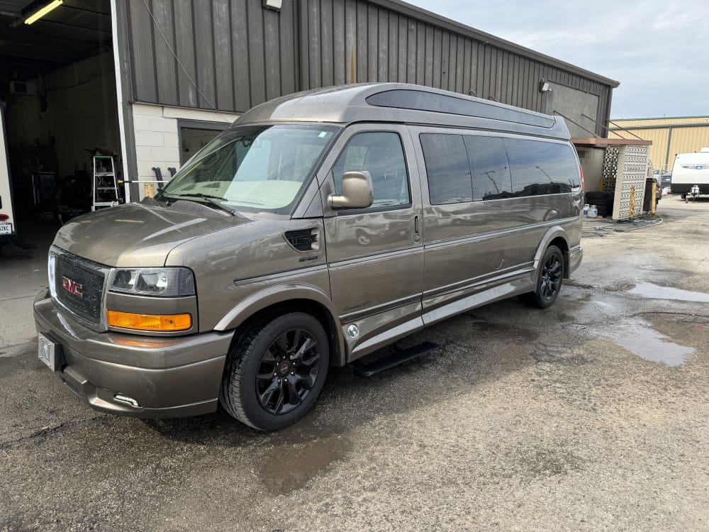 Gray van parked outside a garage