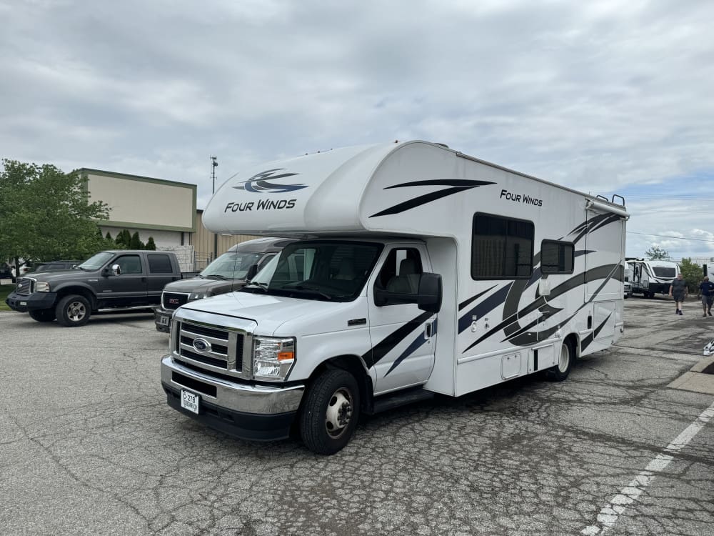 White RV parked on asphalt lot.