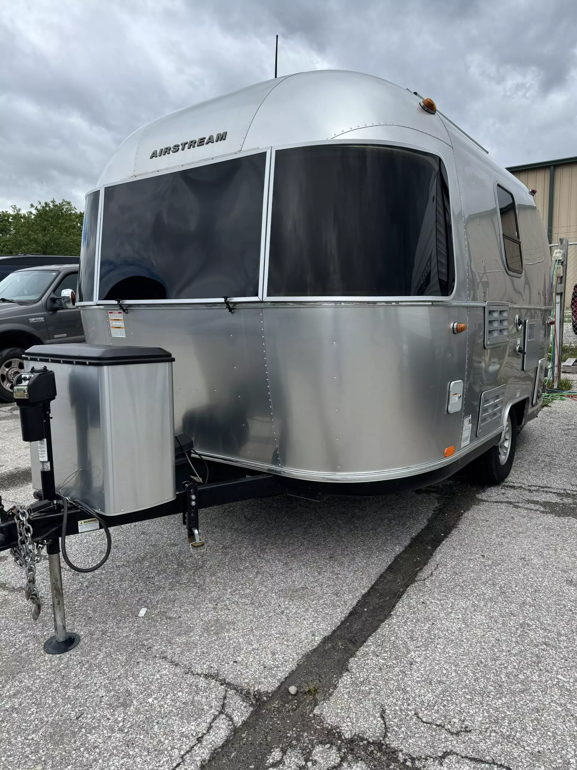 Modern Airstream camper on asphalt driveway