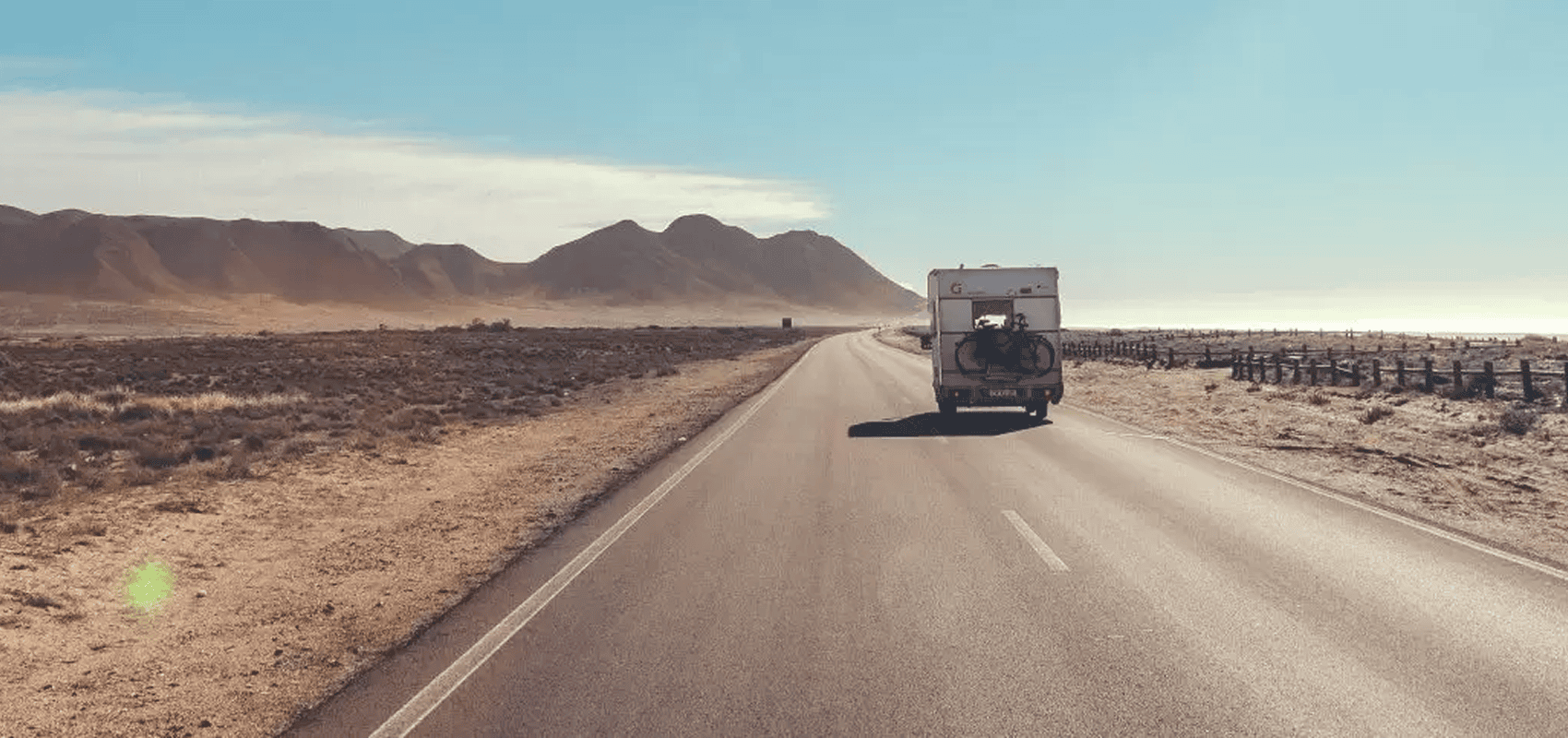 Vehicle driving through arid landscape