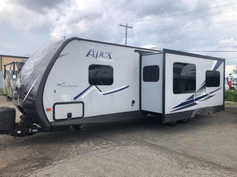 Modern camper trailer under cloudy sky